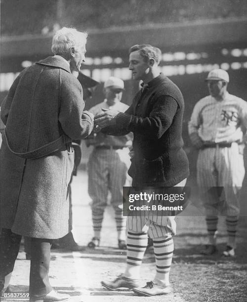 American baseball player Casey Stengel of the New York Giants is cogratulated by baseball commissioner Judge Kenesaw Mountain Landis , New York, New...