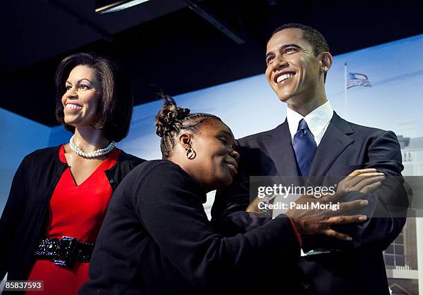 Visitor gives the wax replica of President Barack Obama a hug at the unveiling of a "Michelle Obama" wax figure at Madame Tussauds on April 7, 2009...