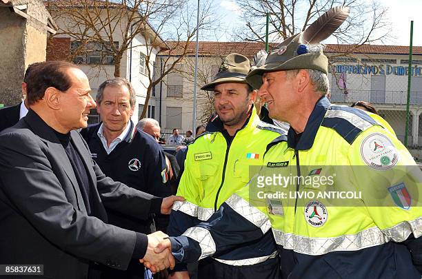 Italy's Prime Minister Silvio Berlusconi meets on April 7, 2009 with volunteers of the civil security during his visit to the San Demetrio camp set...