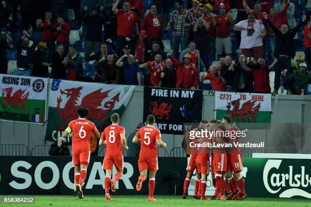Tom Lawrence of Wales celebrates scoring the opening goal with teammates infront of Wales fans during the FIFA 2018 World Cup Qualifier between...