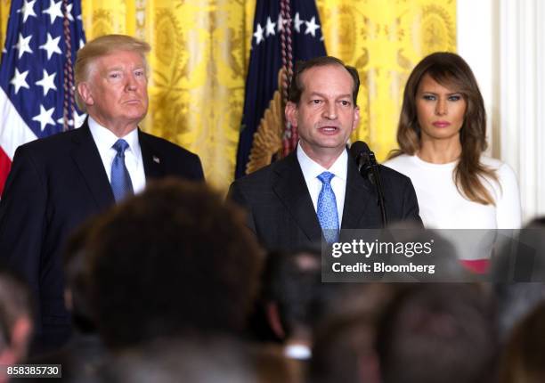 Alexander Acosta, U.S. Labor secretary, center, speaks as U.S. President Donald Trump, left, and U.S. First Lady Melania Trump listen during an...