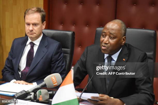 Ivory Coast Prime Minister, Amadou Gon Coulibaly speaks as Spain's ambassador to Ivory Coast, Luis Prados Covarrubias looks on during the signing of...