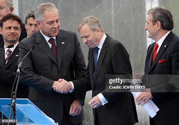 Outgoing NATO Secretary-General Jaap de Hoop Scheffer shakes hands with Croatia Prime Minister Ivo Sanader as Croatian Foreign Minister Gordan...