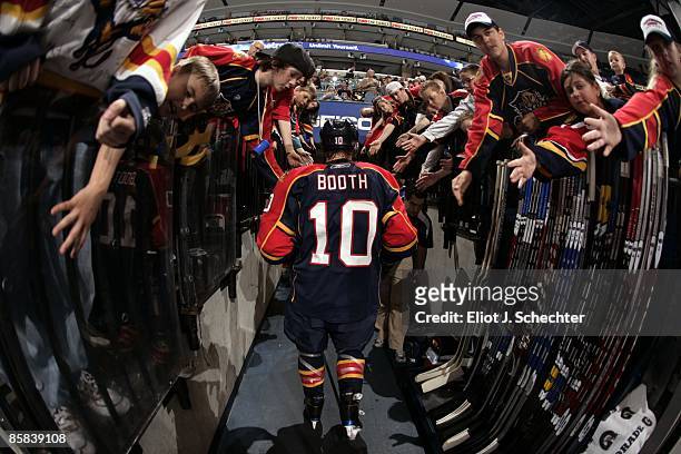 David Booth of the Florida Panthers walks back to the dressing room between periods and is greeted by fans against the Pittsburgh Penguins at the...