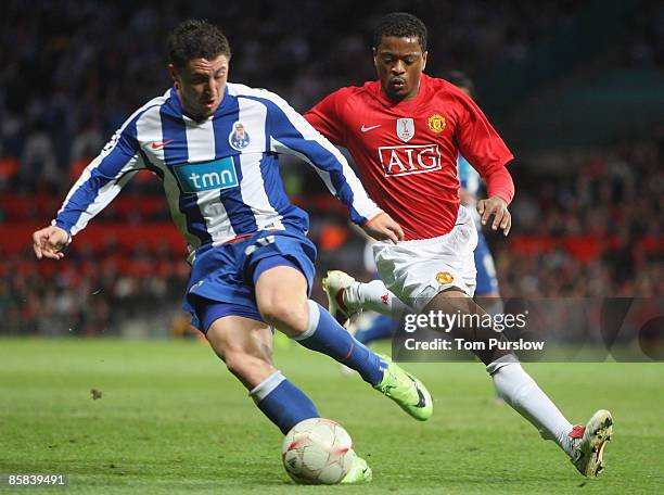 Patrice Evra of Manchester United clashes with Cristian Rodriguez of FC Porto during the UEFA Champions League Quarter-Final First Leg match between...