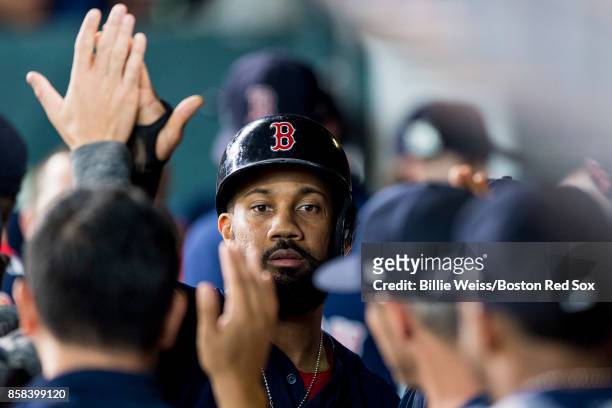 Chris Young of the Boston Red Sox high fives teammates after scoring during the second inning of game two of the American League Division Series...