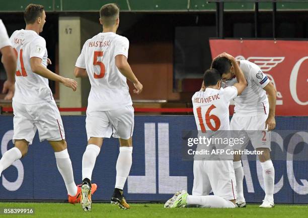 Serbia's Luka Milivojevic celebrates with teammates after scoring a goal during he FIFA World Cup 2018 qualification football match between Austria...