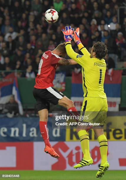 Austria's forward Guido Burgstaller vies with Serbia's goalkeeper Vladimir Stojkovic during the FIFA World Cup 2018 qualification football match...