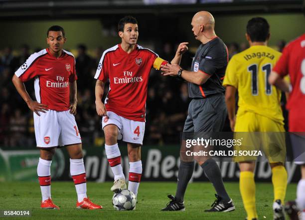 Arsenal's Spanish midfielder and Captain, Cesc Fabregas argues with referee Tom Henning Ovrebo after receiving a yellow card during their Champions...