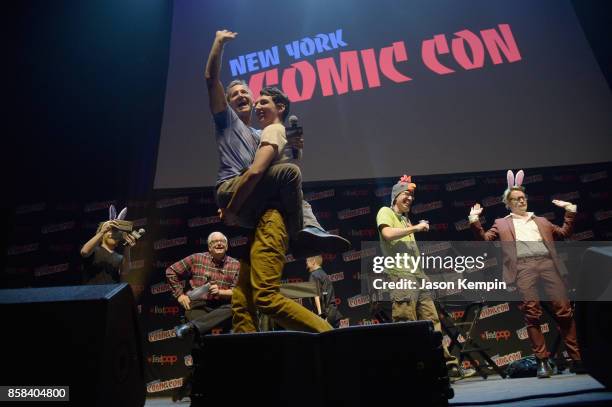 Breckin Meyer is carried onstage as Seth Green, Keith Crofford, Matt Senreich and Macaulay Culkin look on at the Robot Chicken Panel during New York...