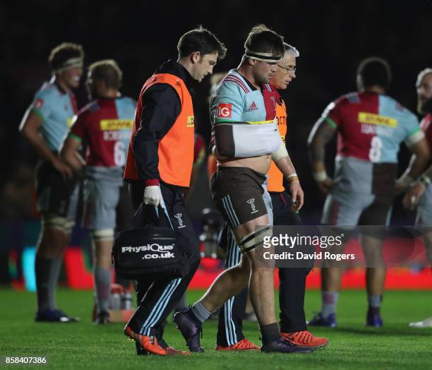 Jack Clifford of Harlequins is helped off the pitch after injurying his arm during the Aviva Premiership match between Harlequins and Sale Sharks...