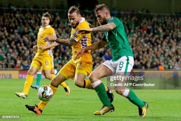 Republic of Ireland's striker Daryl Murphy vies with Moldovia's defender Petru Racu during the FIFA World Cup 2018 qualification football match...