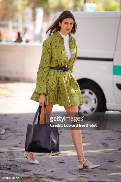 Guest wears a flower print green dress, outside Chanel, during Paris Fashion Week Womenswear Spring/Summer 2018, on October 3, 2017 in Paris, France.