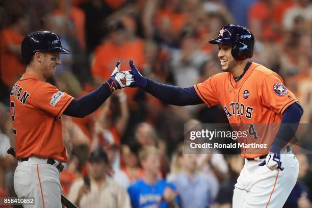 George Springer of the Houston Astros celebrates with Alex Bregman after hitting a solo home run in the third inning against the Boston Red Sox...