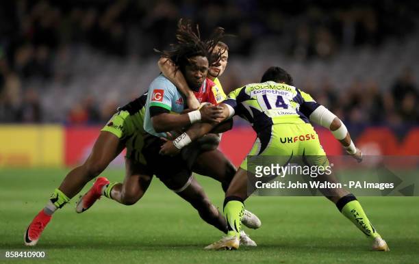 Harlequins' Marland Yarde is tacked by Sale Sharks' Denny Solomonia during the Aviva Premiership match at Twickenham Stoop, London.