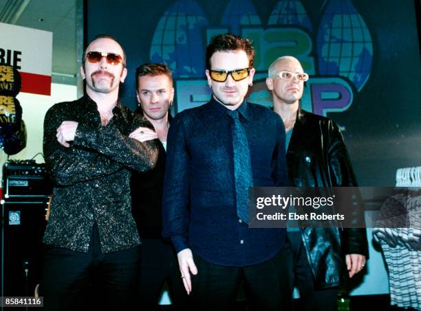 Photo of U2; L-R: The Edge, Larry Mullen Jnr, Bono, Adam Clayton - posed, group shot - at promotional show in Greenwich Village K-Mart shop lingerie...