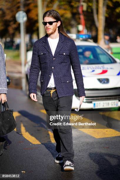 Guest wears a blazer jacket, black pants, outside Chanel, during Paris Fashion Week Womenswear Spring/Summer 2018, on October 3, 2017 in Paris,...