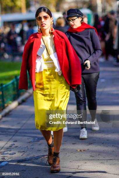 Guest wears a red jacket, a yellow dress, outside Chanel, during Paris Fashion Week Womenswear Spring/Summer 2018, on October 3, 2017 in Paris,...