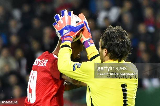Austria's forward Guido Burgstaller vies with Serbia's goalkeeper Vladimir Stojkovic during the FIFA World Cup 2018 qualification football match...