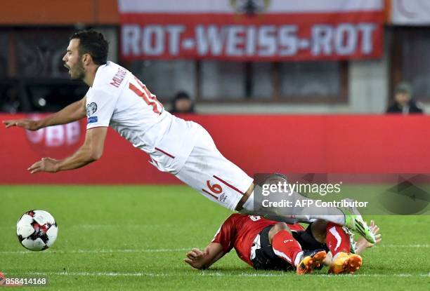 Austria's Stefan Ilsanker falls down as he vies with Serbia's Luka Milivojevic during the FIFA World Cup 2018 qualification football match between...