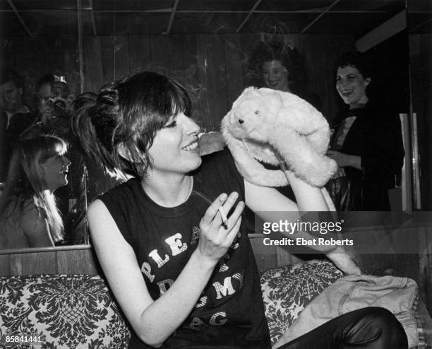 Photo of PRETENDERS and Chrissie HYNDE, Chrissie Hynde backstage with a hand puppet at Toads Place, smoking cigarette