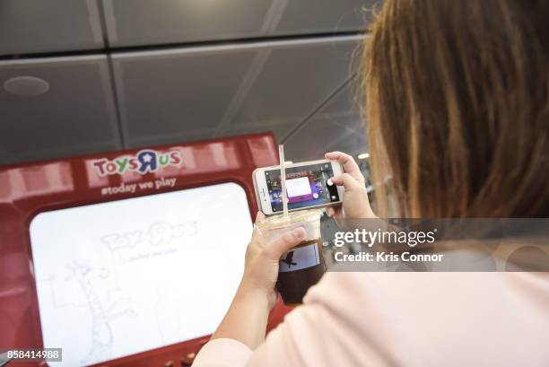 Guest plays with a giant Etch A Sketch during the "Toys "R" Us Takes Over Fulton Street Subway Station with Giant Etch A Sketch," event at Fulton...