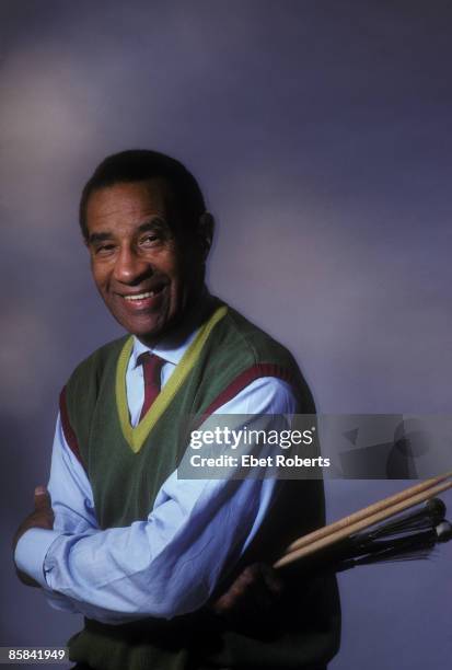 Photo of Max ROACH; studio, posed, with drum sticks