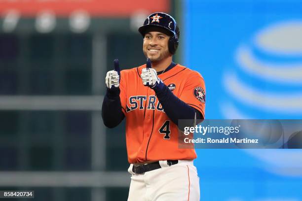 George Springer of the Houston Astros reacts on second base after hitting a double in the fourth inning against the Boston Red Sox during game two of...