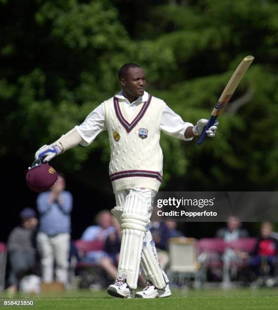 Brian Lara of the West Indies acknowledges applause as he reaches his century during the Tour match between West Indies and Zimbabwe as part of...