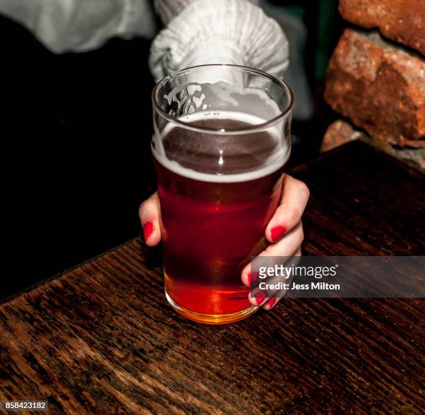 Woman holding glass of bear