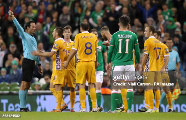 Match referee Bas Nijhuis shows a red card to Moldova's Alexandru Gatcan during the 2018 FIFA World Cup Qualifying, Group D match at the Aviva...