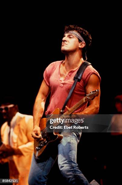Photo of Bruce SPRINGSTEEN; with Clarence Clemons behind - E-Street Band, performing live onstage on Born In The USA tour, c.1984/1985