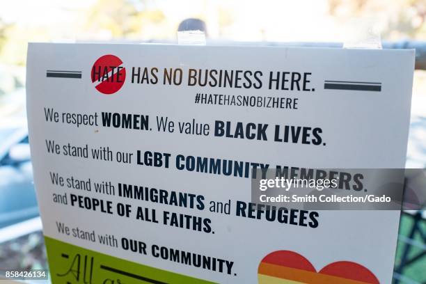 Poster in a shop window in Berkeley, California, reading "Hate has no business here", and listing several causes, including Black Lives Matter and...