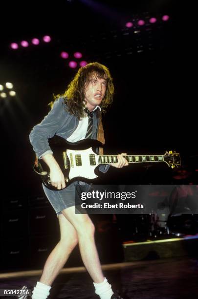 Photo of AC DC and AC/DC and Angus YOUNG; Angus Young performing live onstage, playing Gibson SG guitar