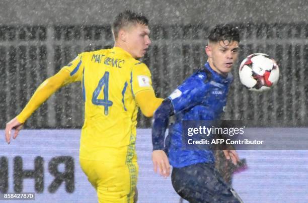 Ukraine's defender Mykola Matviyenko fights for the ball with Kosovo's midfielder Milot Rashica during the FIFA World Cup 2018 qualification football...