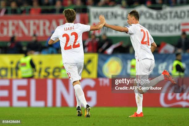 Serbia's Adem Ljacic and Nemanja Matic celebrate after scoring a goal during the FIFA World Cup 2018 qualification football match between Austria and...