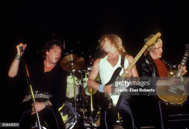 Photo of Dave MURRAY and IRON MAIDEN and Paul DI'ANNO and Adrian SMITH; L-R: Paul Di'Anno, Dave Murray and Adrian Smith performing live onstage on...