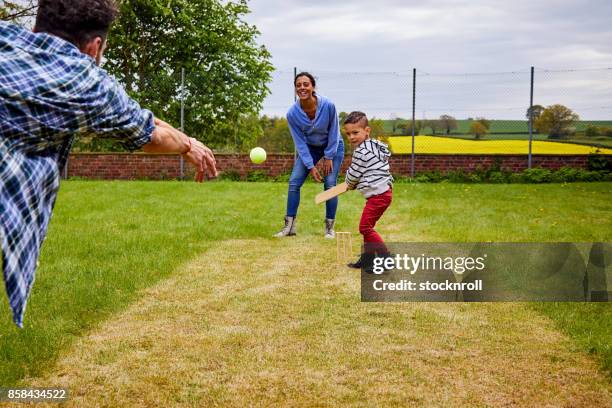 little boy playing with his parents - cricket player portrait stock pictures, royalty-free photos & images