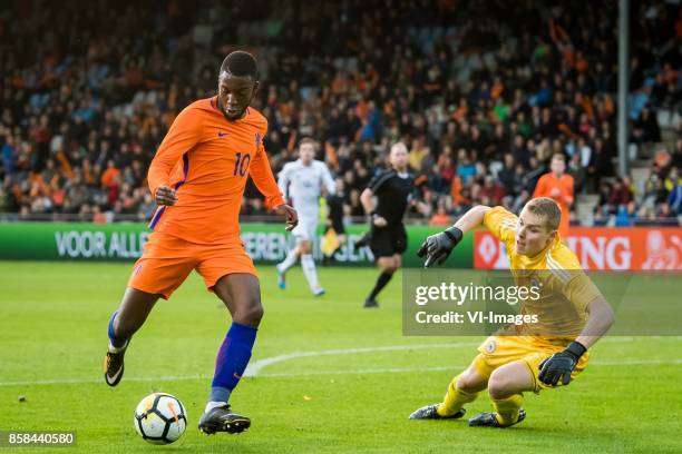 Riechedly Bazoer of Jong Oranje, goalkeeper Kurakins Vladislavs of Jong Letland during the EURO U21 2017 qualifying match between Netherlands U21 and...