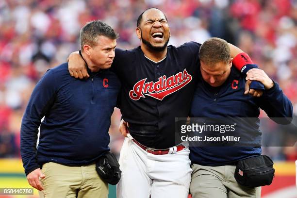 Edwin Encarnacion of the Cleveland Indians receives medical attention after an injury first inning against the New York Yankees during game two of...