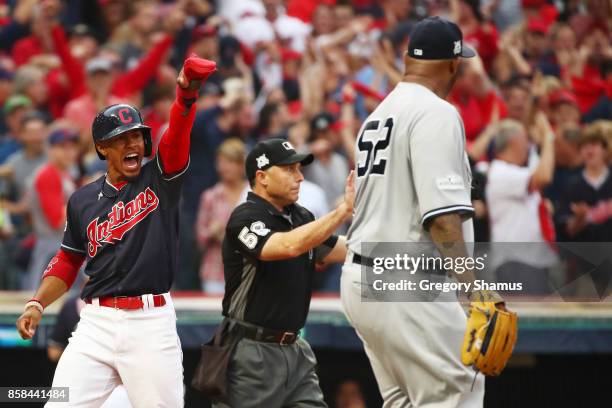 Francisco Lindor of the Cleveland Indians celebrates scoring on a hit by Carlos Santana in the first inning as CC Sabathia of the New York Yankees...