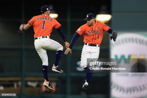 Carlos Correa and George Springer of the Houston Astros celebrate defeating the Boston Red Sox 8-2 in game two of the American League Division Series...