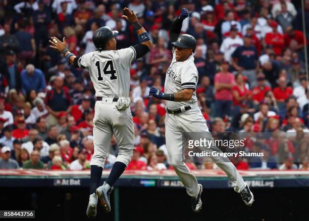 Aaron Hicks celebrates his three-run home run with Starlin Castro of the New York Yankees in the against the Cleveland Indians third inning during...
