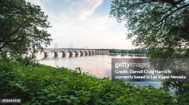 train bridge over the susquehanna river in harrisburg pennsylvania - susquehanna river stock pictures, royalty-free photos & images