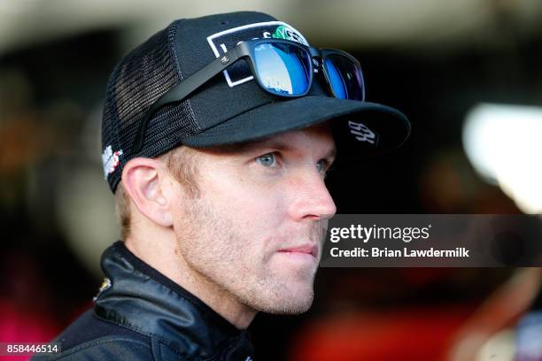 Blake Koch, driver of the LeafFilter Gutter Protection Chevrolet, looks on from the garage during practice for the NASCAR XFINITY Series Drive for...