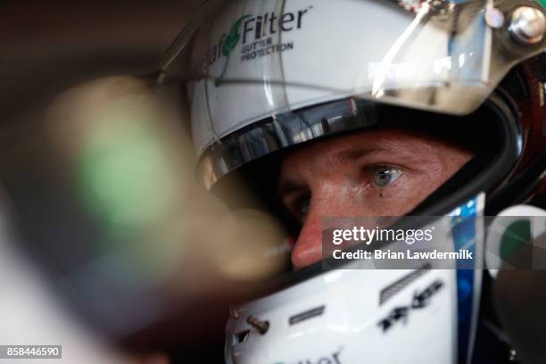 Blake Koch, driver of the LeafFilter Gutter Protection Chevrolet, sits in his car during practice for the NASCAR XFINITY Series Drive for the Cure...