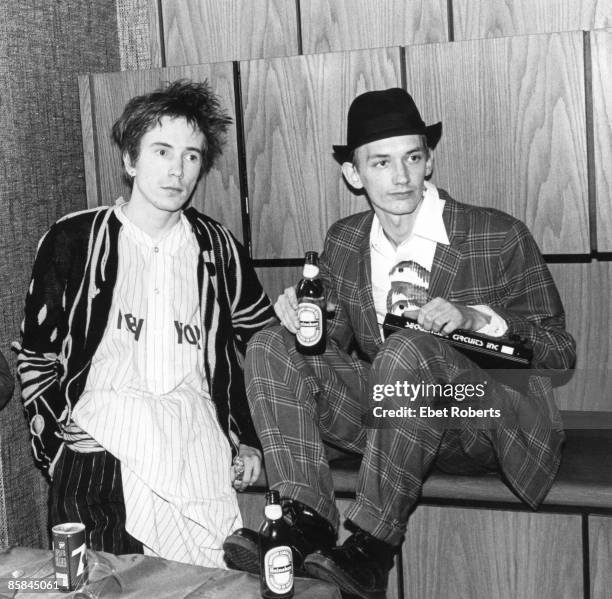 Keith LEVENE and PIL and John LYDON and PUBLIC IMAGE LTD; L-R: John Lydon, Keith Levene holding bottles of Heineken beer.