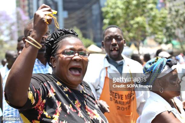 Opposition supporter shout as they protest over the electoral reforms before the 26th October repeat presidential election ant-riot police tear...