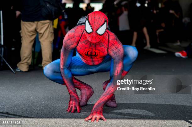 Fan cosplays as Spider-Man from the Marvel universe during 2017 New York Comic Con - Day 2 on October 6, 2017 in New York City.