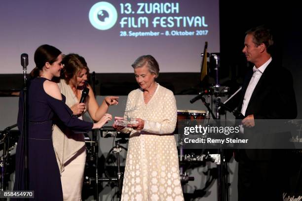 Claire Foy and Claudia Bluemhuber hand over the Silver Reel award to Diana Cavendish and Jonathan Cavendish on stage at the Tommy Hilfiger VIP Dinner...